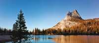 Cathedral Peak reflects in the blue waters of the Upper Cathedral Lake in Yosemite National Park