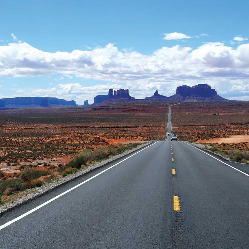 A long open road through Monument Valley | Jake Hutchins