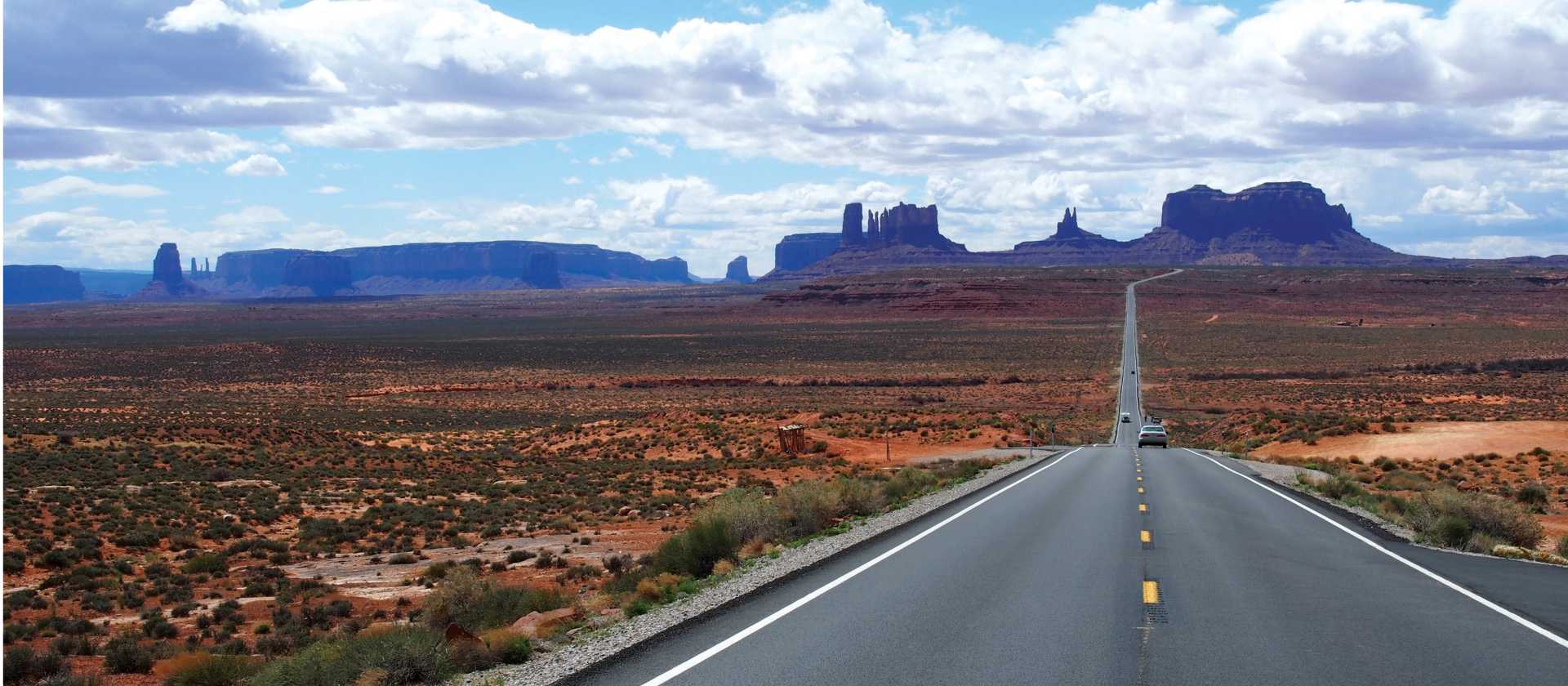 A long open road through Monument Valley | Jake Hutchins